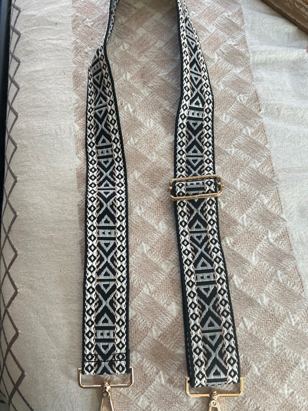 White/black/brown pattern crossbody strap